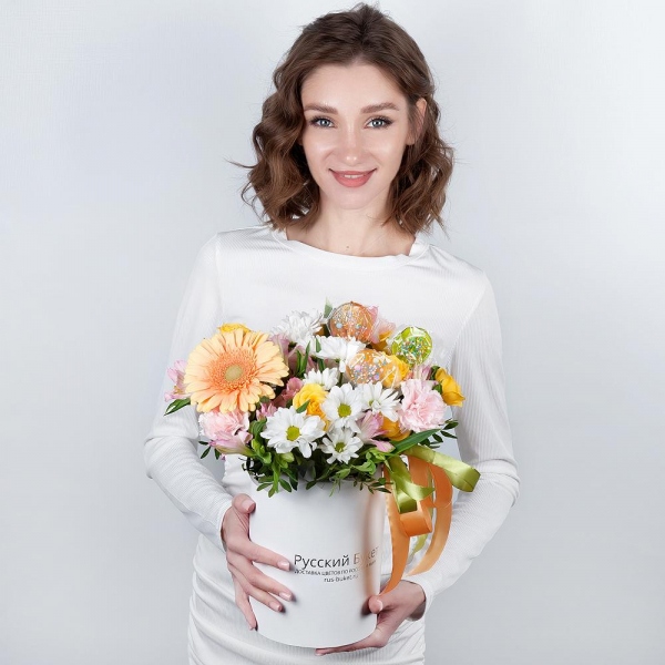 Gerbera yellow - 1, Pink carnation - 4, Alstromeria white, soft pink - 3, Bacardi White Spray Chrysanthemum - 2, Spray rose: yellow, orange 50 cm - 1, Round flower box small , Ribbon, Oasis, Pistachio, Topper (for flowers)