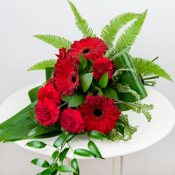 Carnation red - 8, Gerbera red - 7, Ambrella, Ruscus italian, Ruscus, Aspidistra (1 pc.), Ribbon
