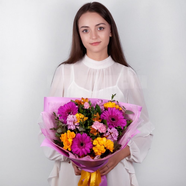 Purple gerbera - 3, Pink Hyacinth - 3, Alstromeria Yellow, Orange - 4, Pink spray carnation - 4, Freesia - 4, Pistachio, Eucalyptus, Wrapping Paper